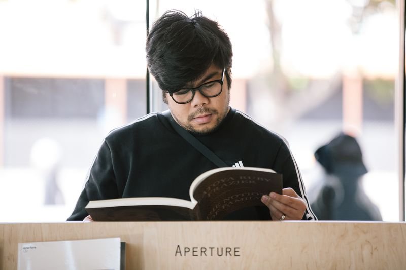 Student accessing photography books at CCA's YBCA located Curatorial Research Bureau