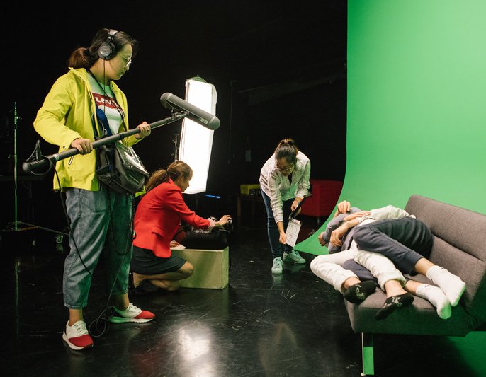 During class, CCA film students in film cage establish camera angles, staging, and lighting