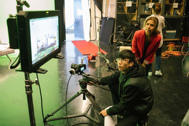CCA film student shoots on a green screen and reviews footage with faculty