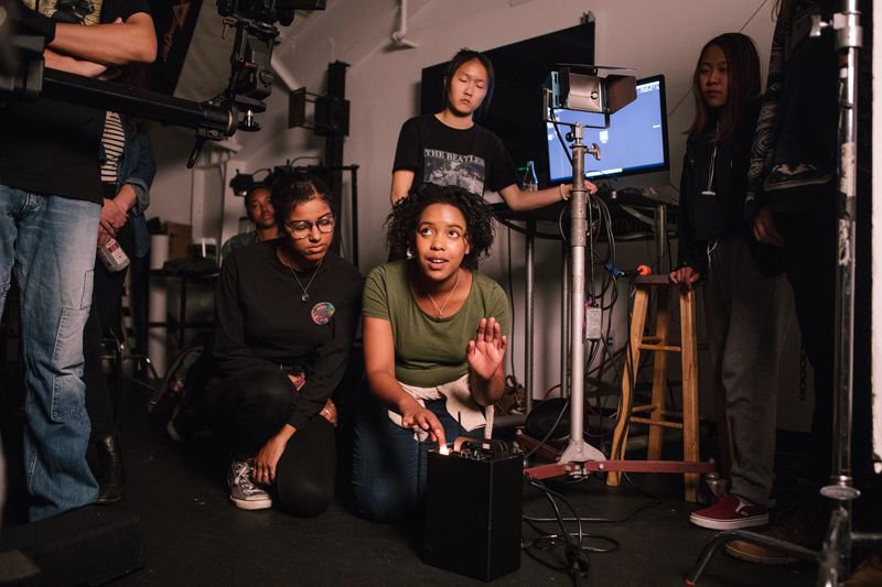 Photography students learn to adjust lighting and stage photoshoots