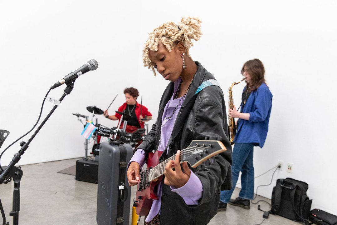 Three student musicians perform on CCA's campus.
