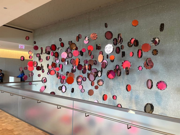 Circle glass hanging in shades of red and brown.