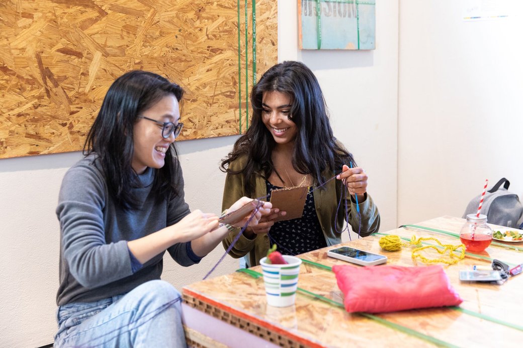 Two students collaborate in a hands-on workshop at the "Where do we go from here?" event.