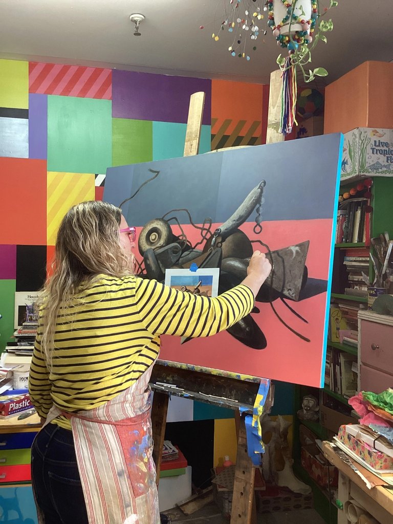 Fonda painting in her studio.