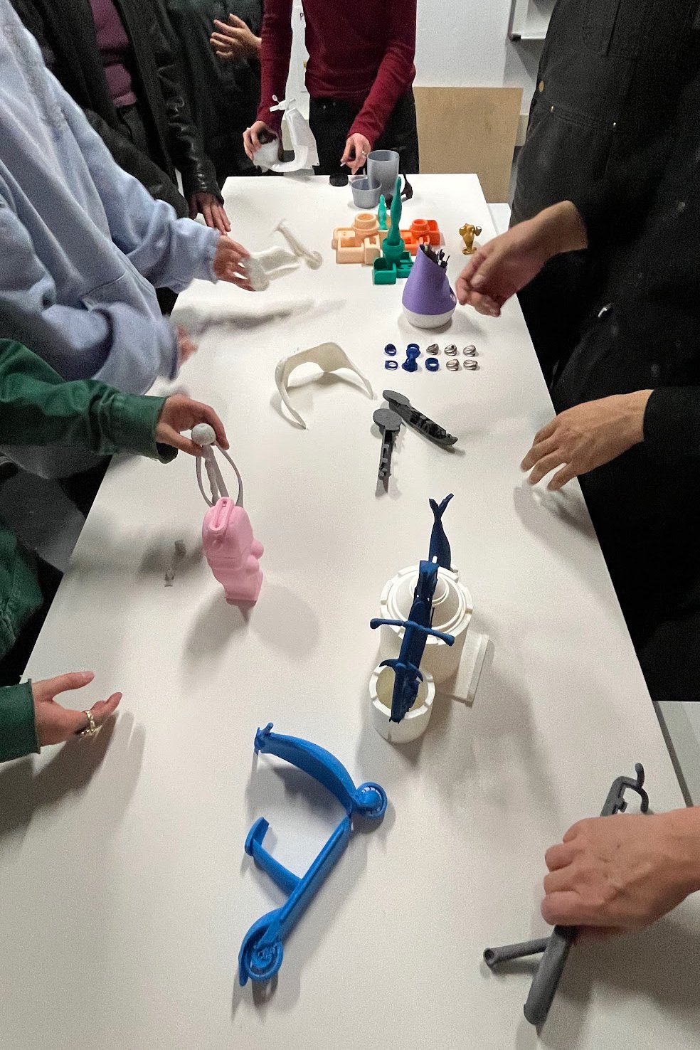 A table displaying architectural models and 3D printed objects.