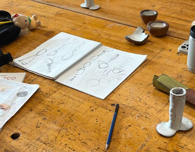 A sketch book on a wooden table.