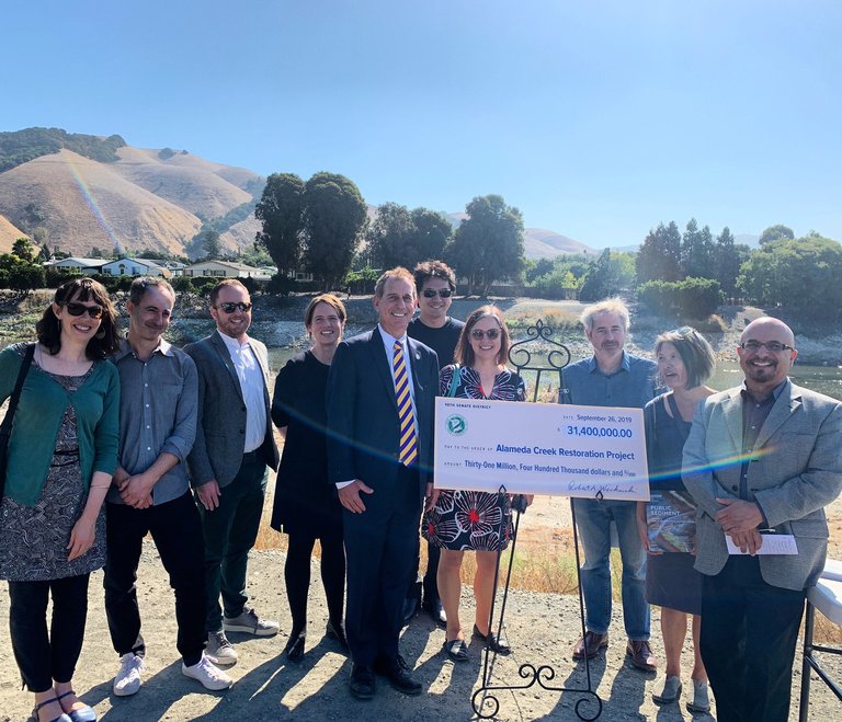 Public Sediment’s interdisciplinary team poses with their $31.4 million-dollar check for the Alameda Creek restoration project.