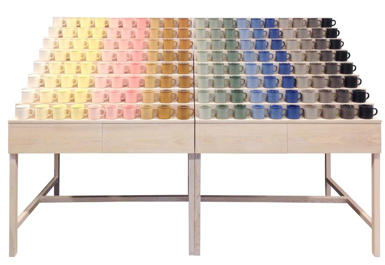 Colorful display of ceramic mugs by Atelier Dion.
