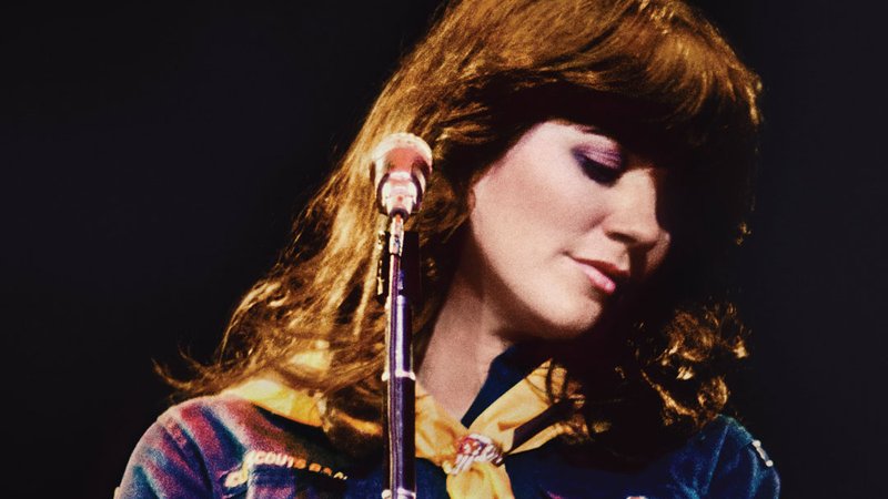 Movie poster for the film Linda Ronstadt: The Sound of My Voice, with the musician standing at the microphone with her head turned.