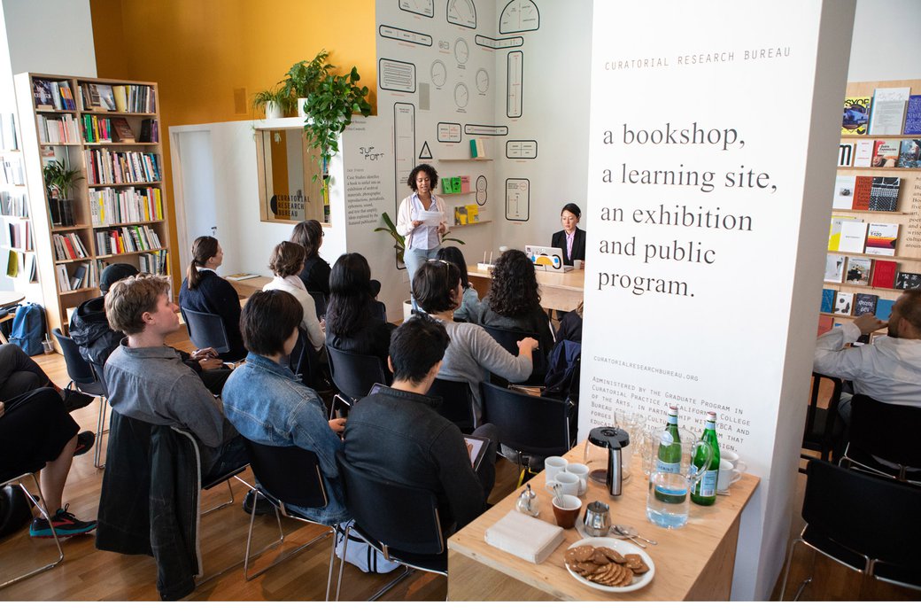 A student introduces a guest speaker at the Curatorial Research Bureau