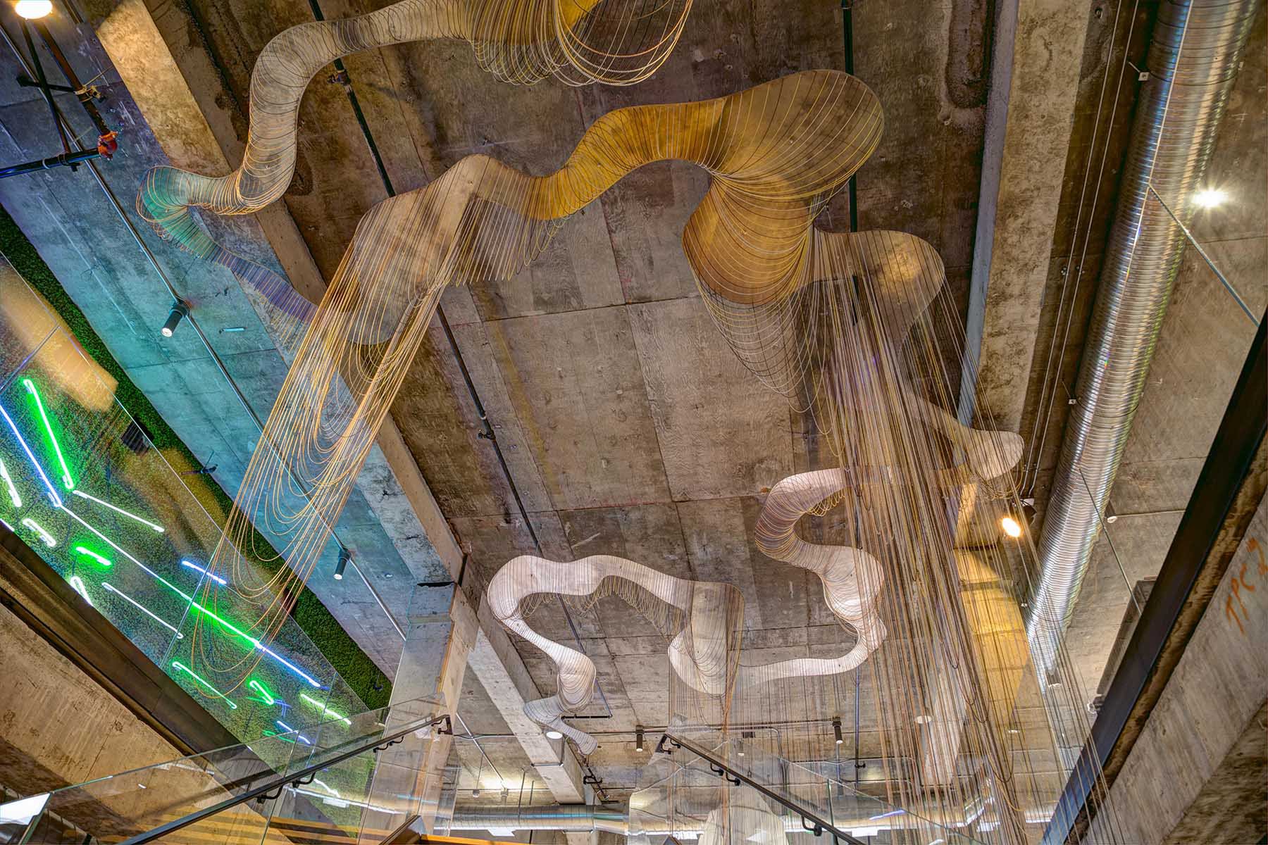 An immersive sculpture made of 11,000 feet of ball chain hanging from the ceiling.