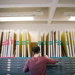 Student cataloguing silkscreens in the screen printing room