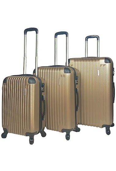 Ensemble de trois valises champagnes extensibles en ABS renforcé.