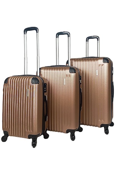 Ensemble de trois valises roses or extensibles en ABS renforcé.