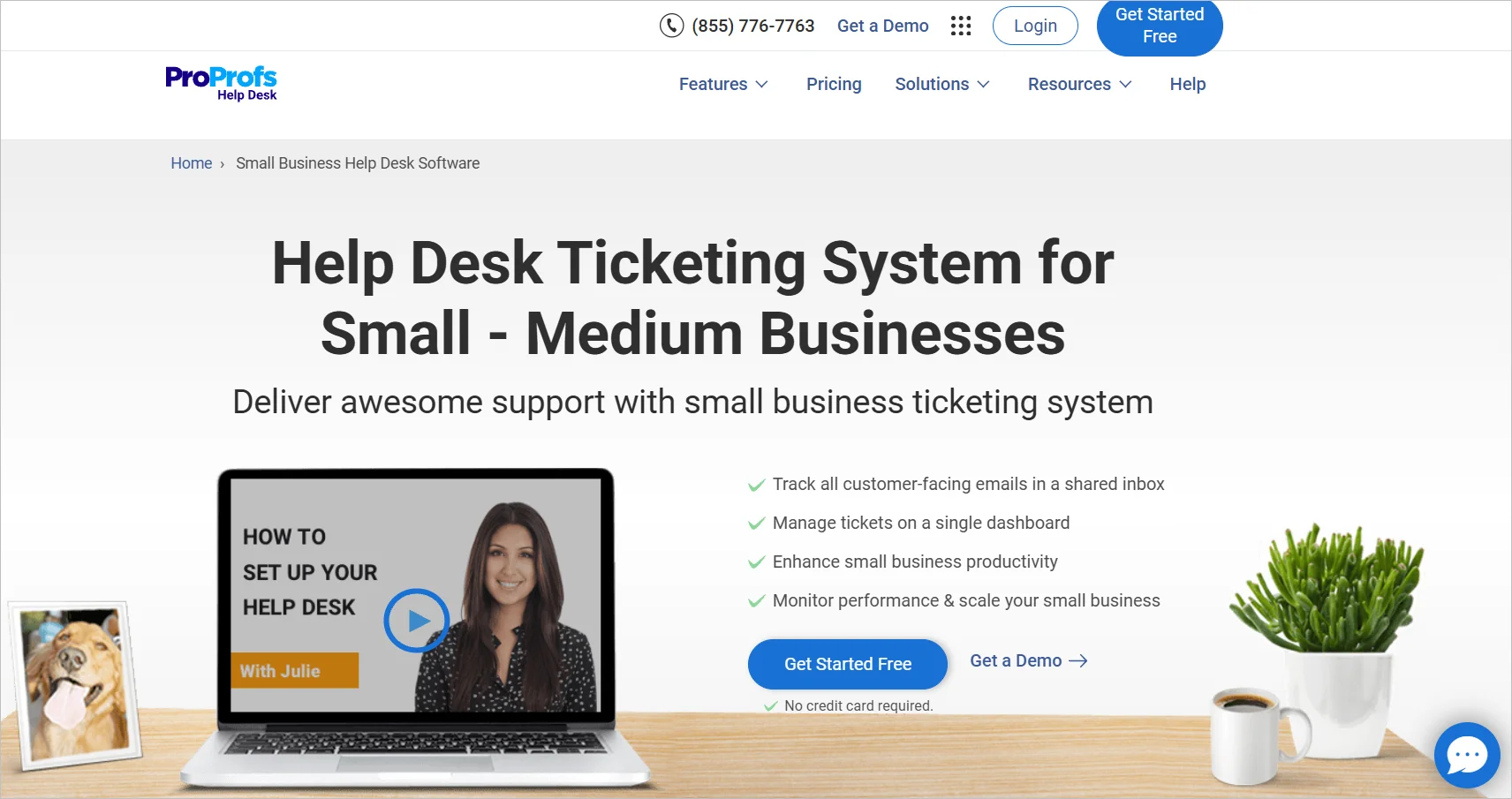 ProProfs Help Desk webpage showing shared inbox features, laptop on desk with dog photo, plant, and coffee cup nearby