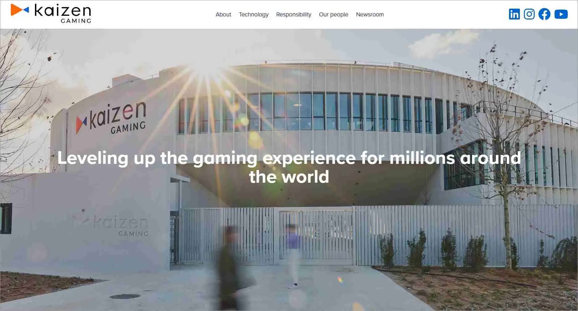 Kaizen Gaming homepage featuring a large modern building with curved architecture and vertical glass panels. The Kaizen Gaming logo is displayed on the left side of the building