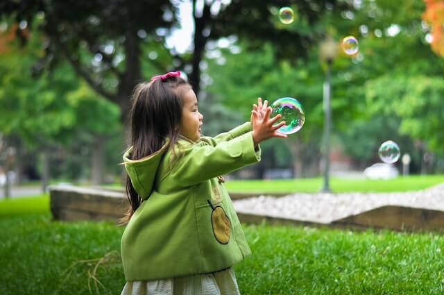 Kid playing with bubbles