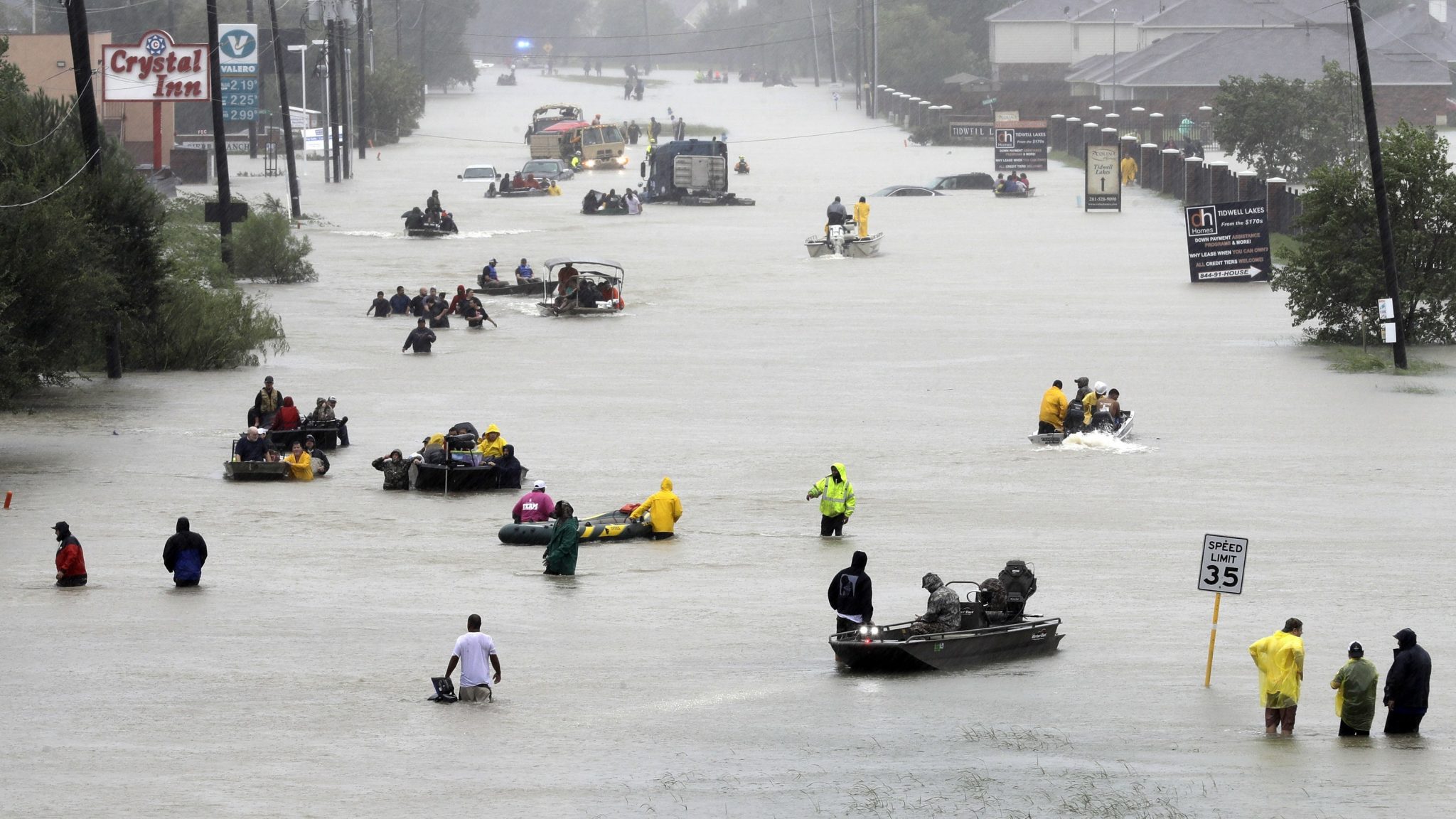 Rescue boats fill a flooded street in Houston after Hurricane Harvey, 2017 (David J Phillip/AP)