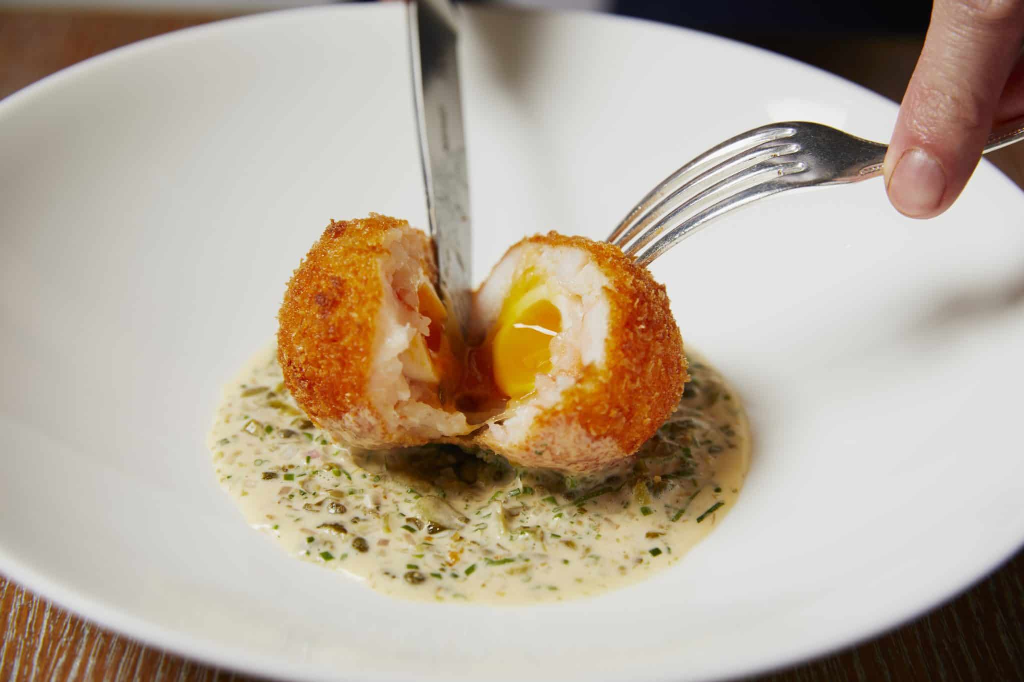 The Grill at The Dorchester-Prawn scotch egg-breaking open-highres