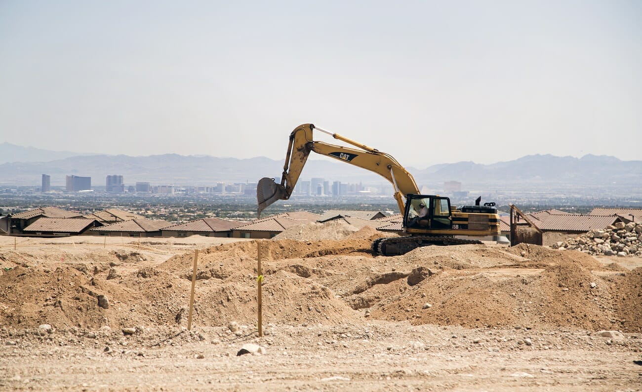 A backhoe on a cleared lot