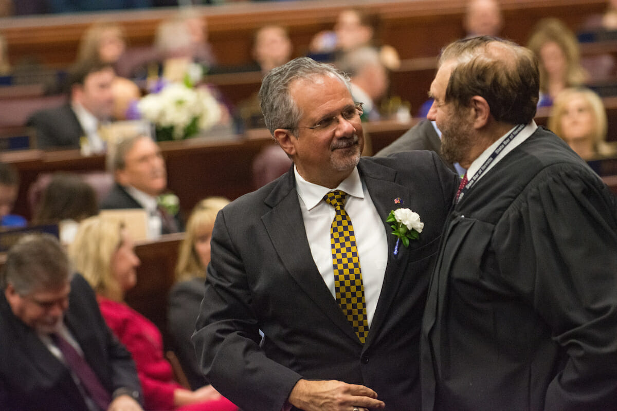 Ozzie Fumo shaking hands with an unknown man at the NV Legislature