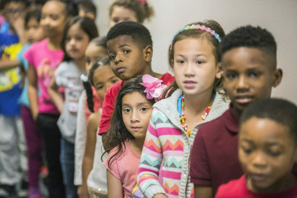 Elementary students standing in the hallway