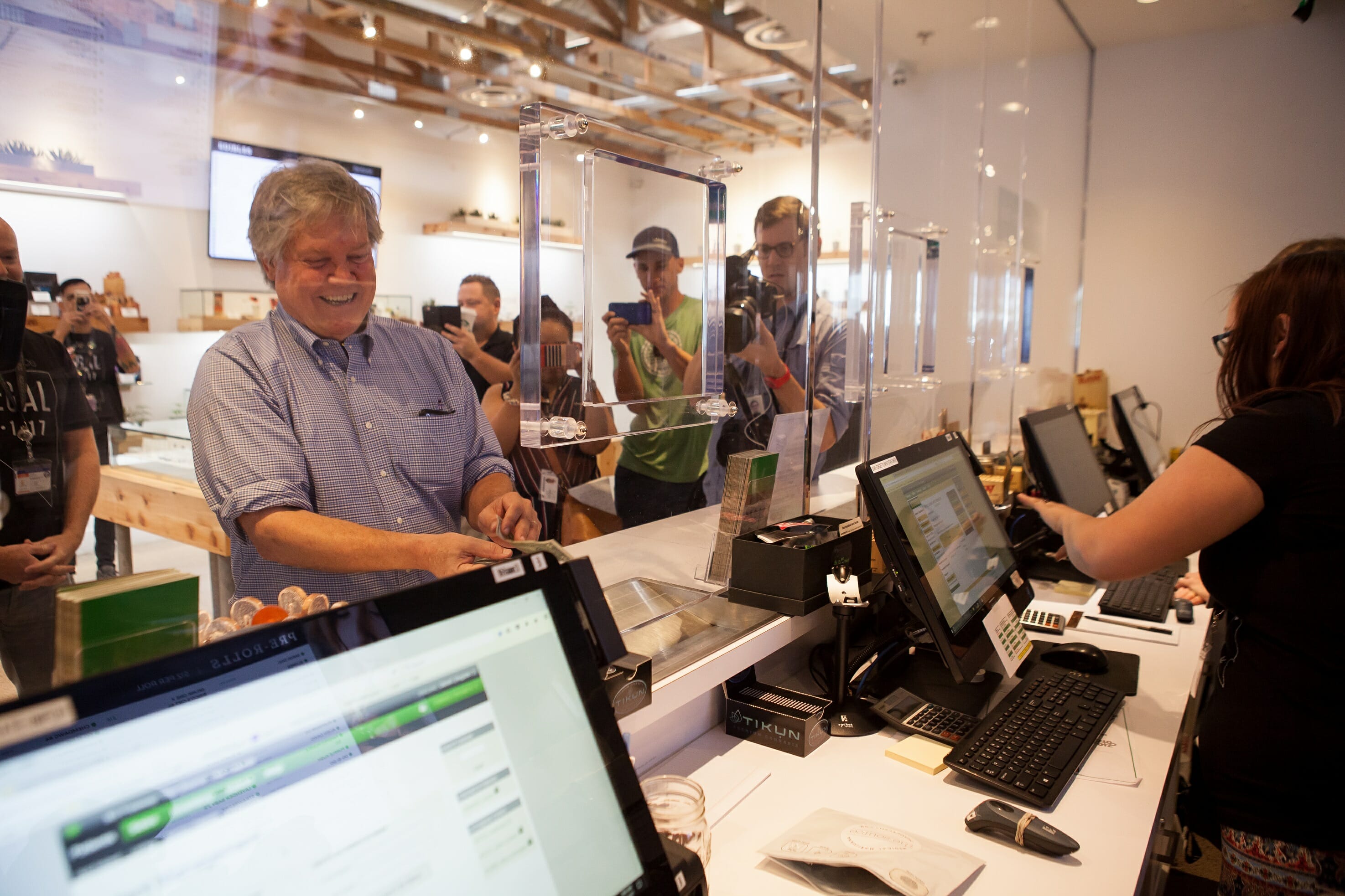 Senator Tick Segerblom standing in front of a cash register