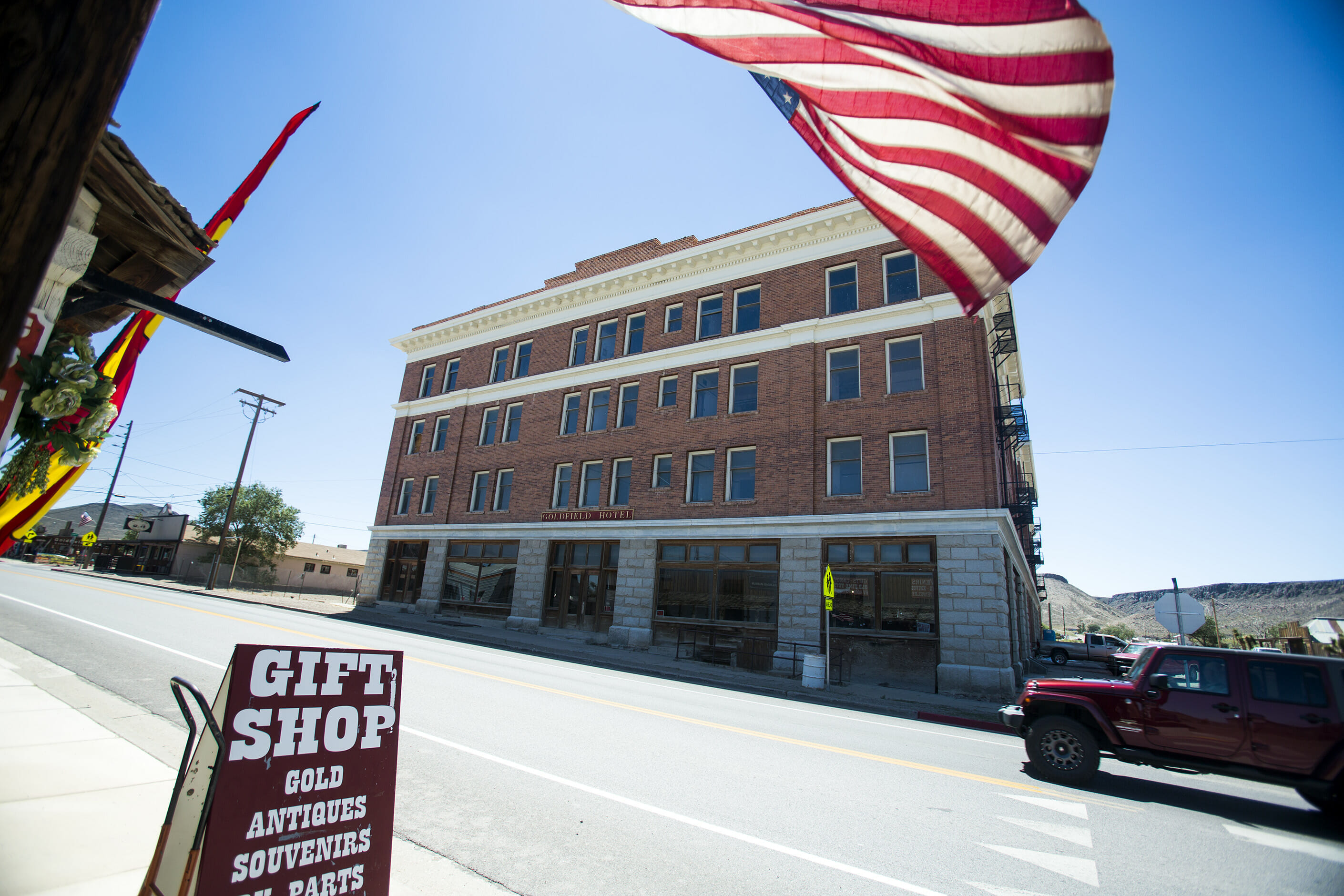 Front of The Goldfield Hotel on a sunny day with the US Flag waving in front