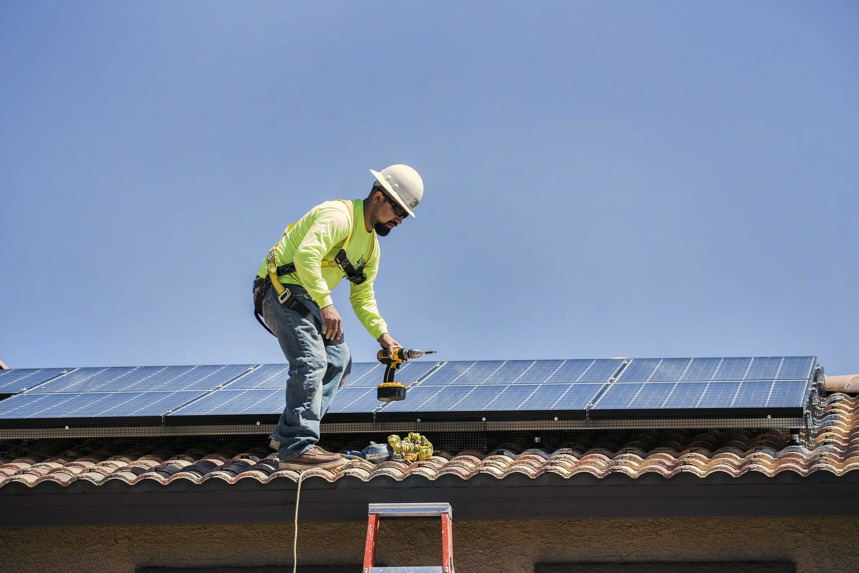 Electrician Mario Rojas with 1 Sun Solar inspects solar panels in Las Vegas