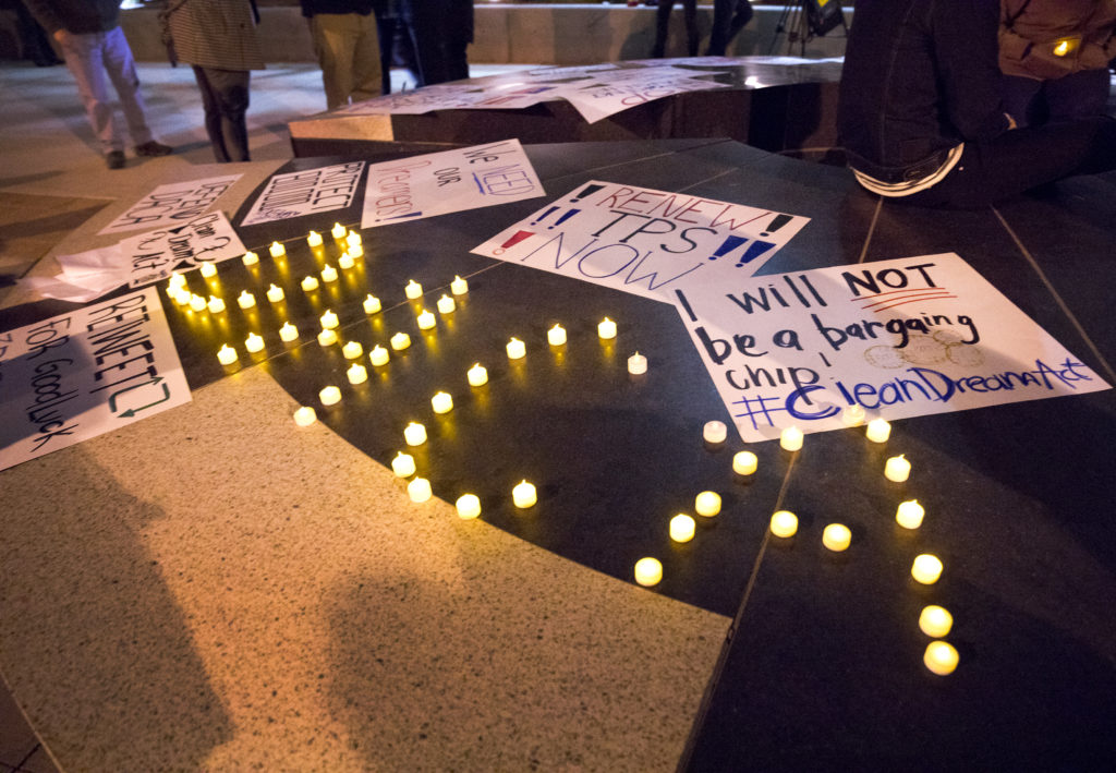 Candles on a table spell out DACA