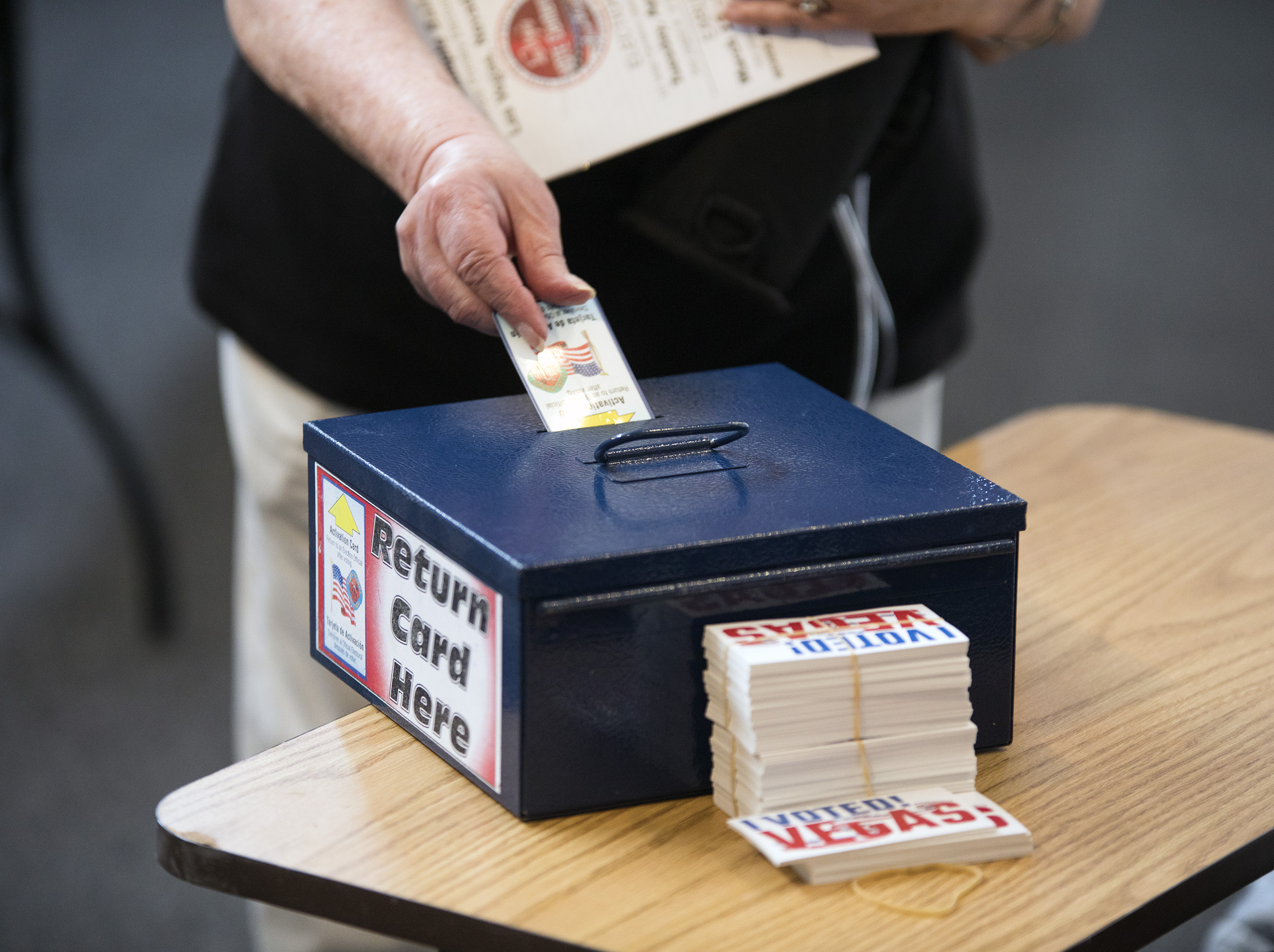 A women turns in her ballot