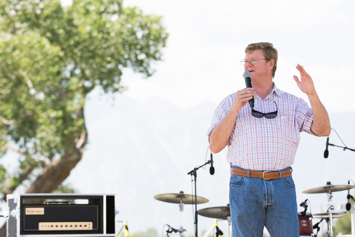 Adam Laxalt on stage with microphone while speaking