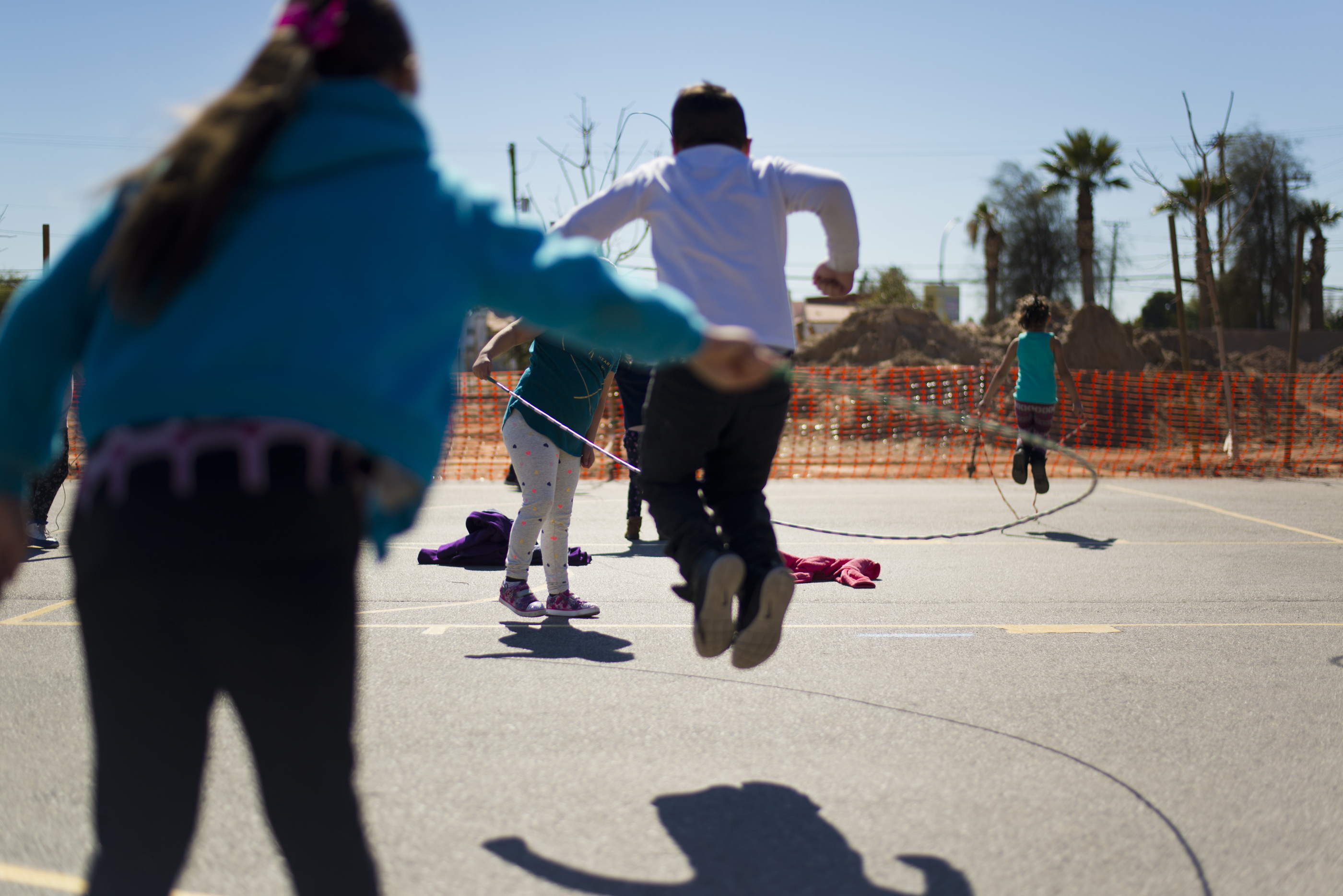 Children playing jump-rope on a playground