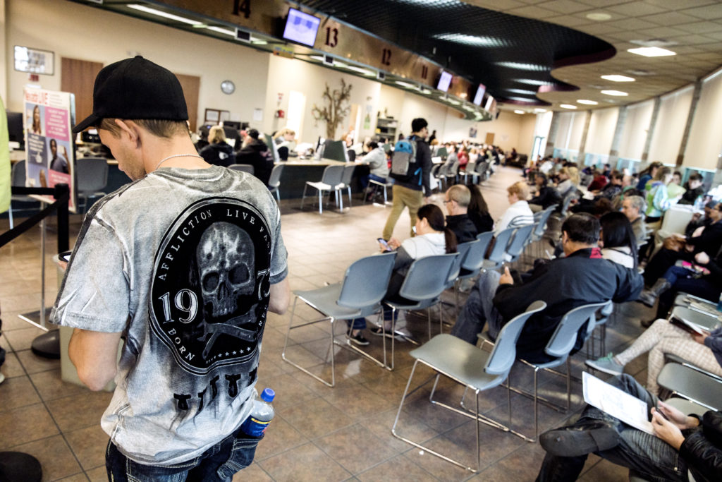People wait at the DMV office in Henderson on Tuesday, Jan. 2, 2018