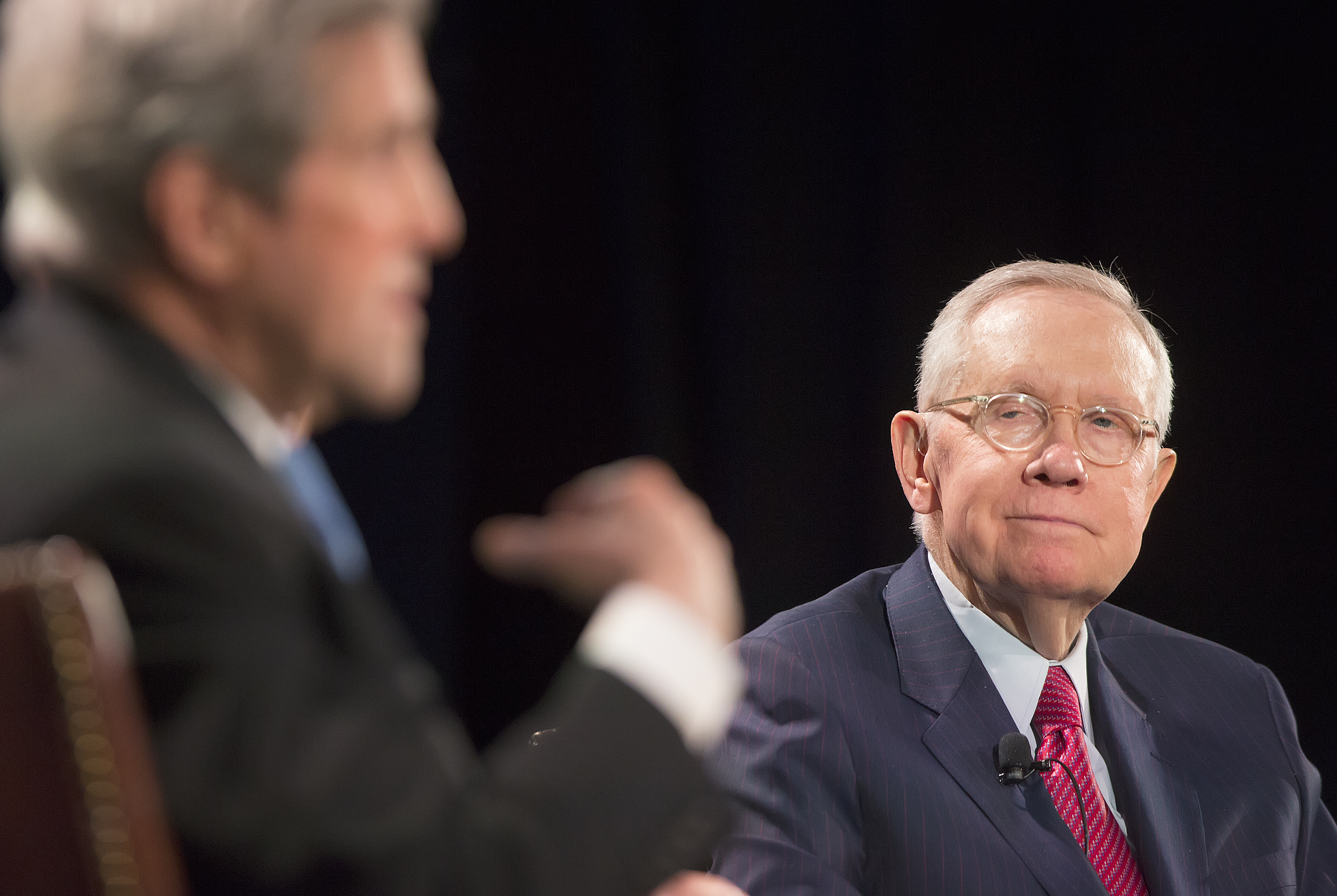 Harry Reid in a blue sport coat with red tie