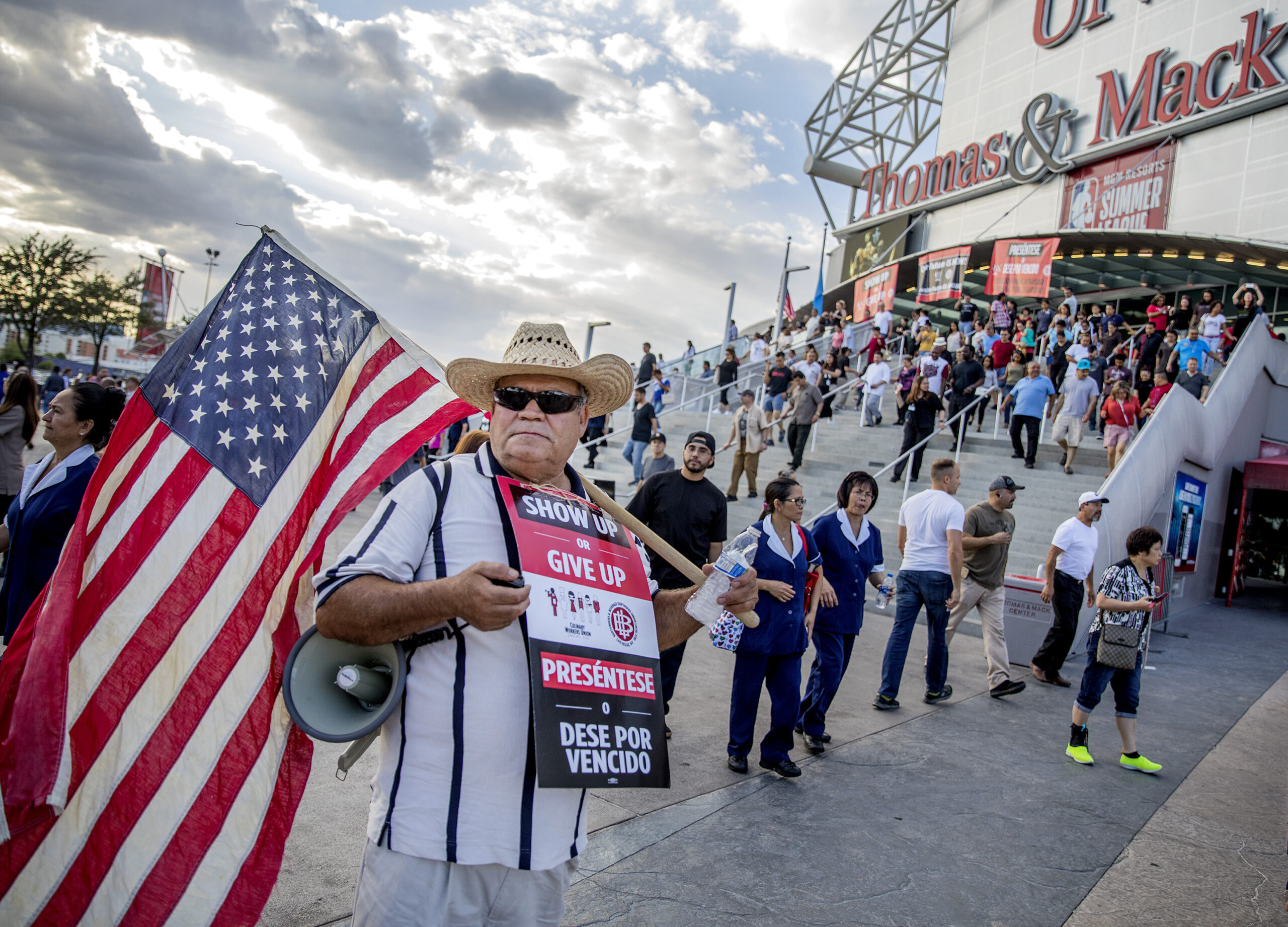 Union member stands holding flag