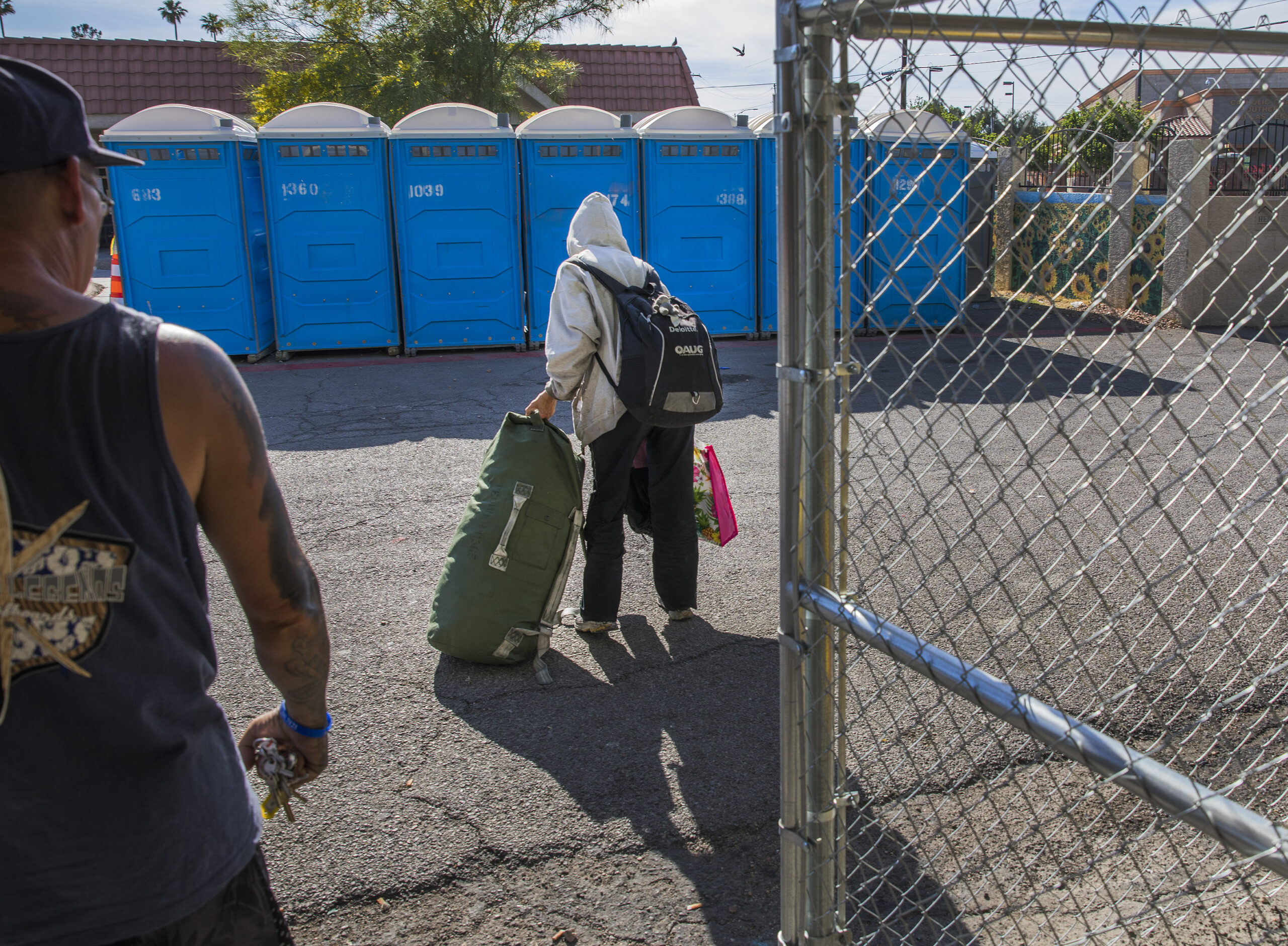 A woman carries her belongings at The Courtyard, a city of Las Vegas operated day shelter for homeless