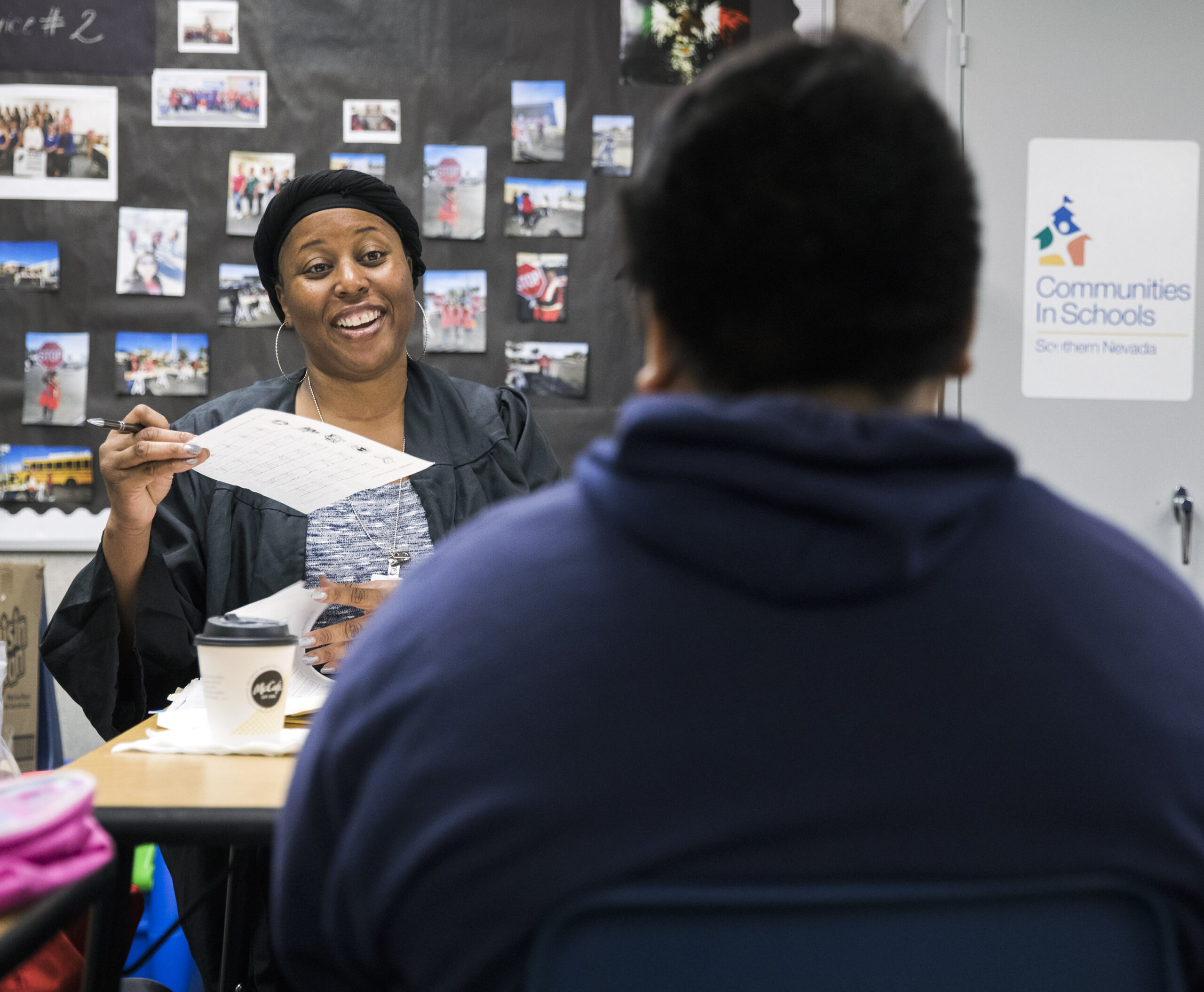 Kimmie Webb with the Truancy Diversion Program congratulates a student on improvement