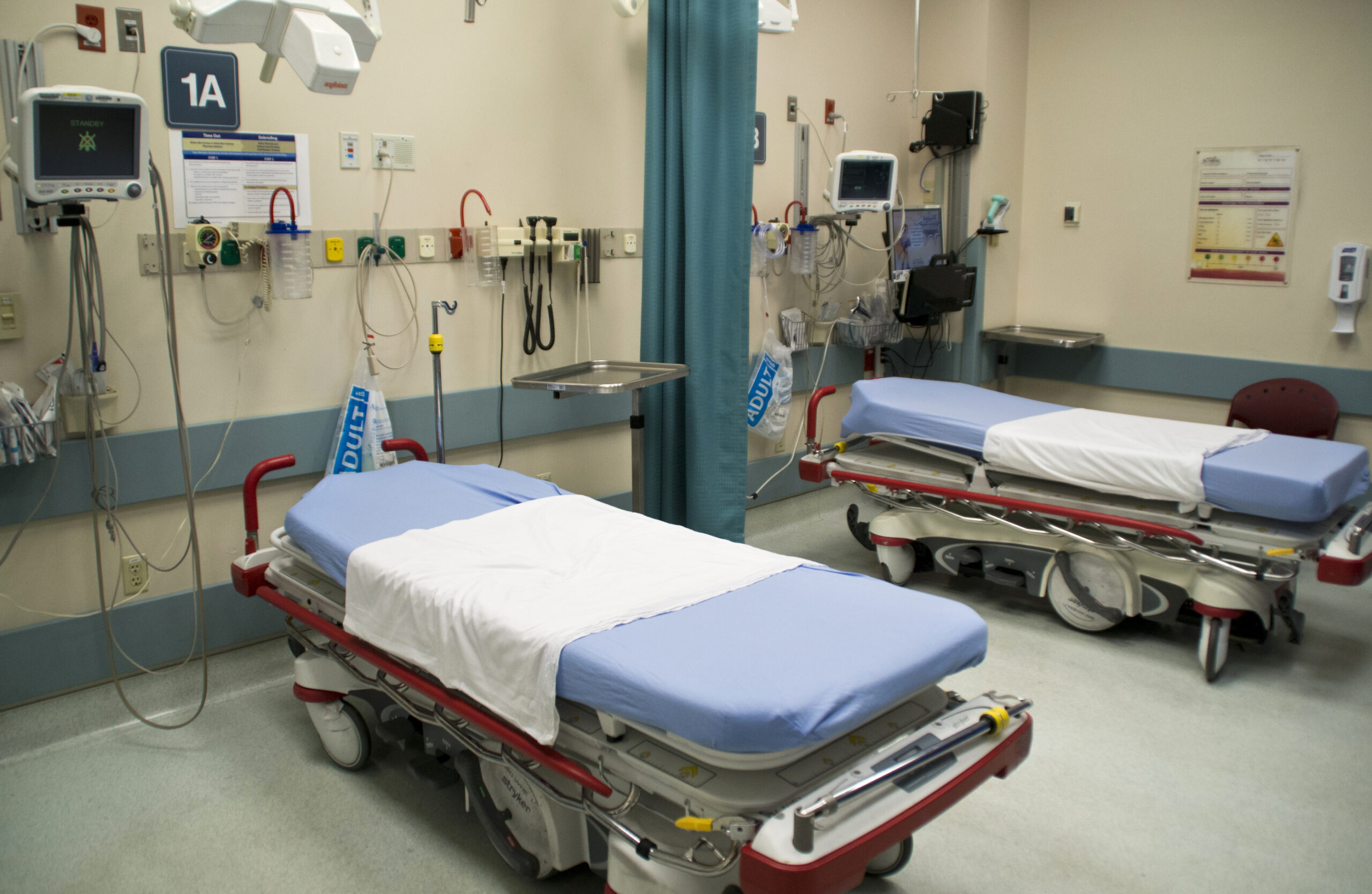 Two empty beds in an emergency room
