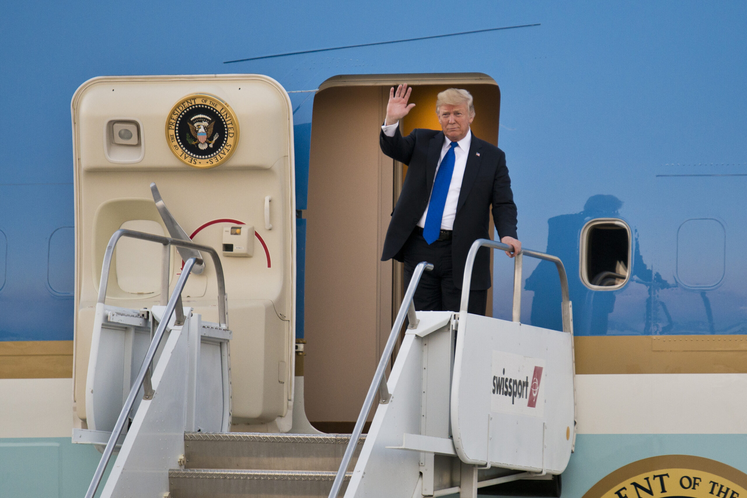 President Donald Trump waiving from the entrance door to Air Force One