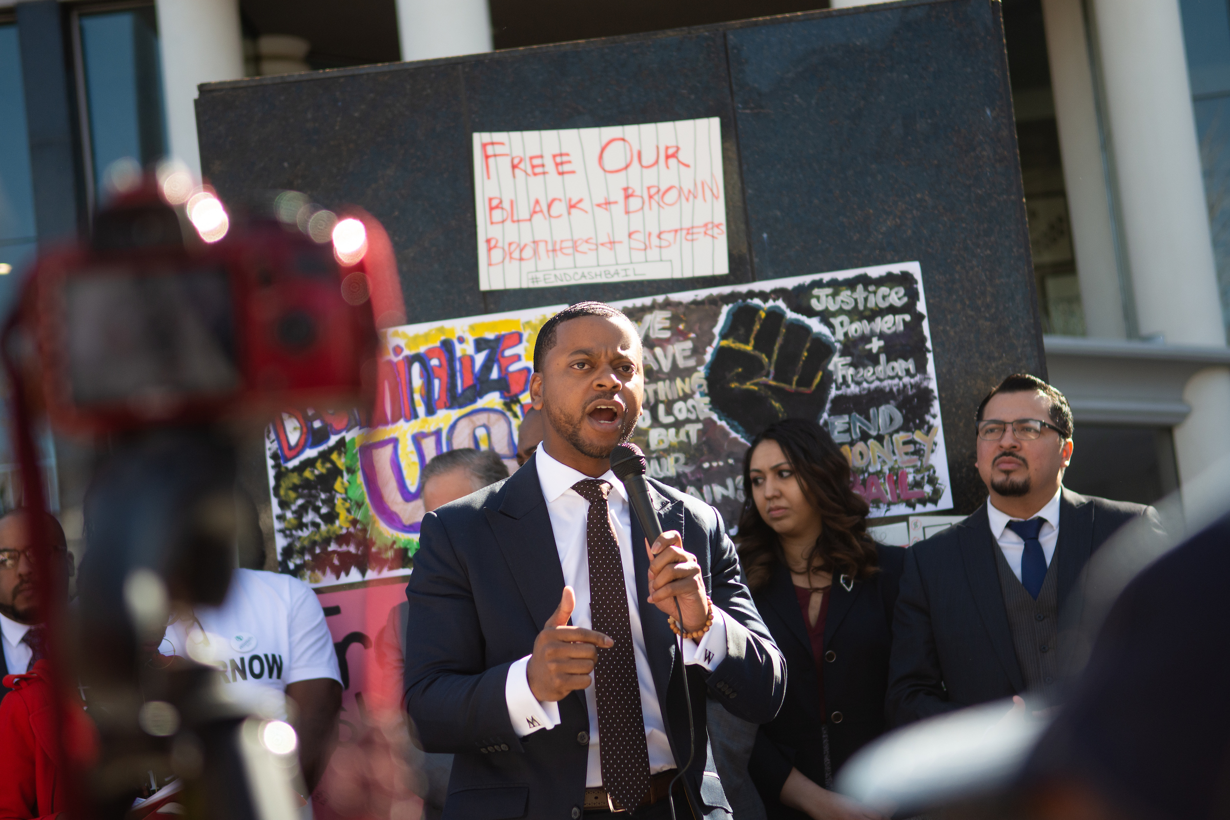 William McCurdy speaking into a microphone during a protest against cash bail outside of the Nevada Legislature