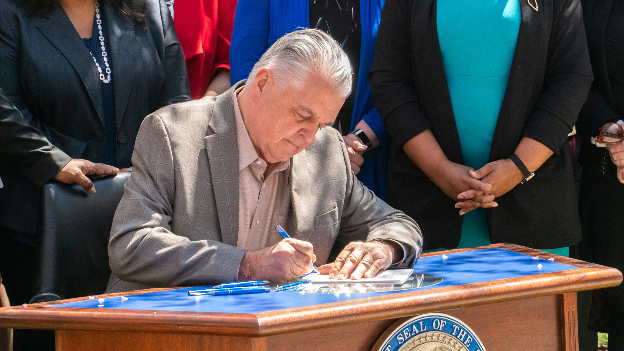 Gov. Sisolak signing SB358 on Earth Day outside of the legislature