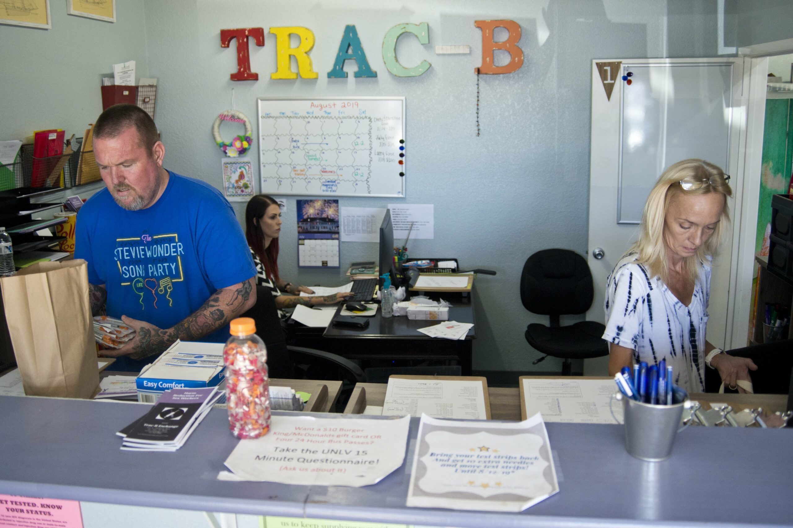 A man and woman sitting at a desk filling orders