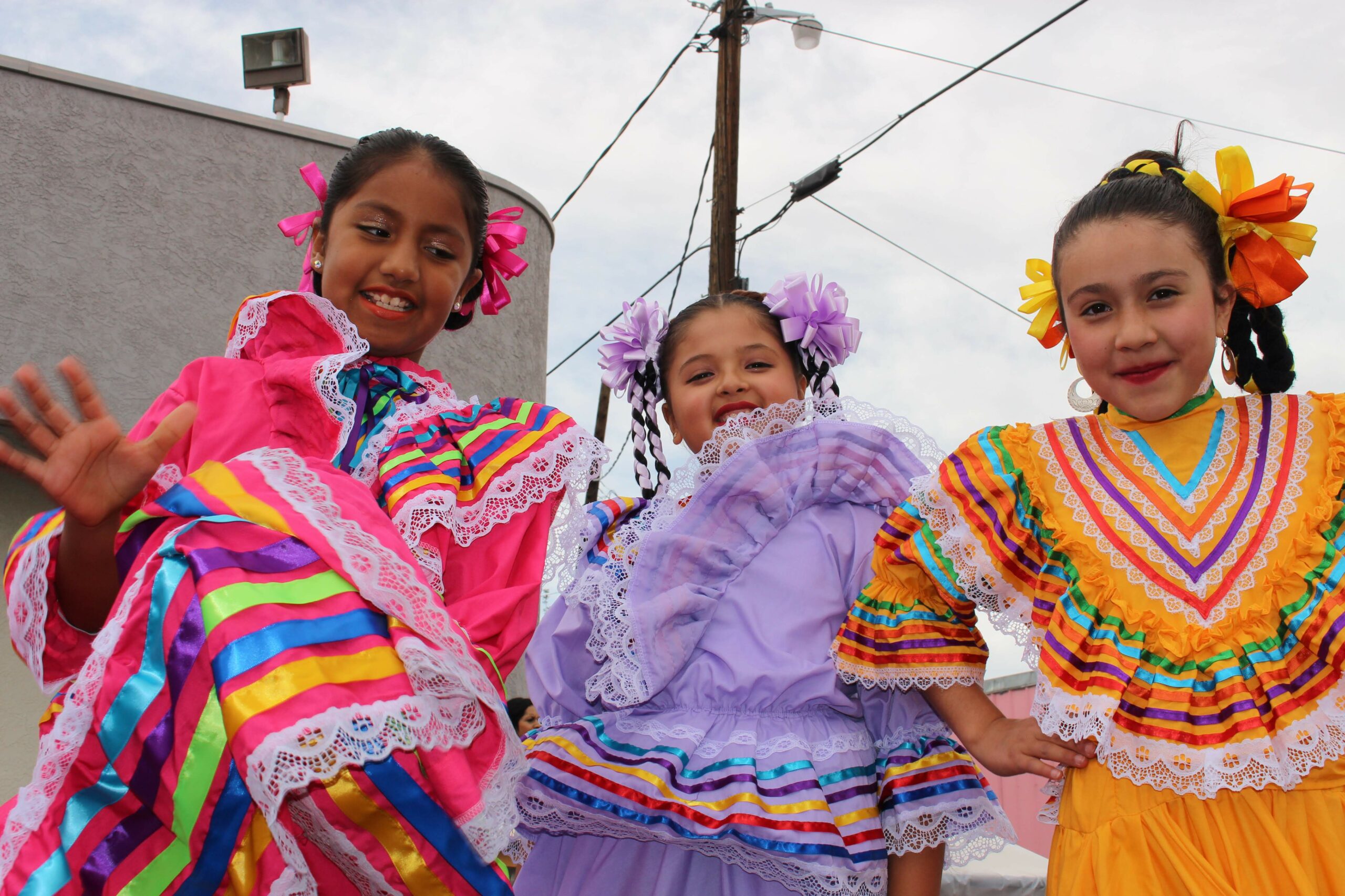 Three young girls after their performance of ballet folklorico at a Reno event celebrating Mexico’s Independence Day