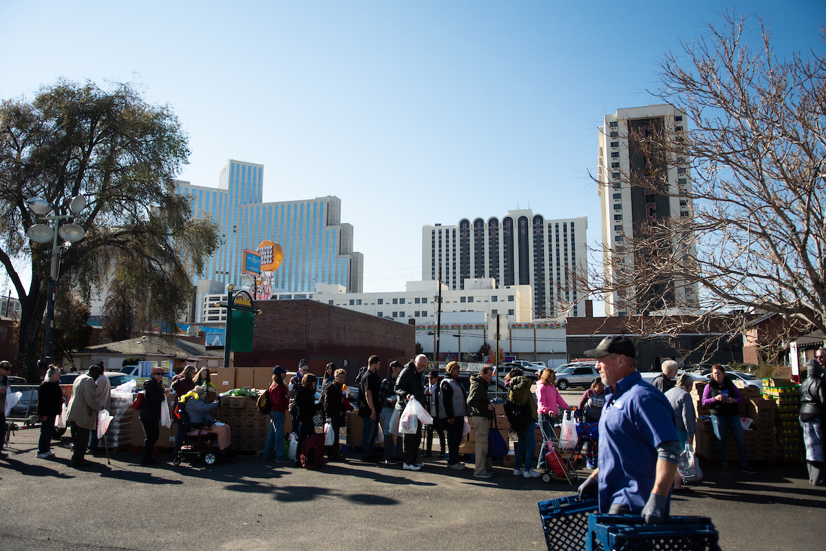 Community members line up at the Food Bank of Northern Nevada's mobile pantry to receive bags of groceries