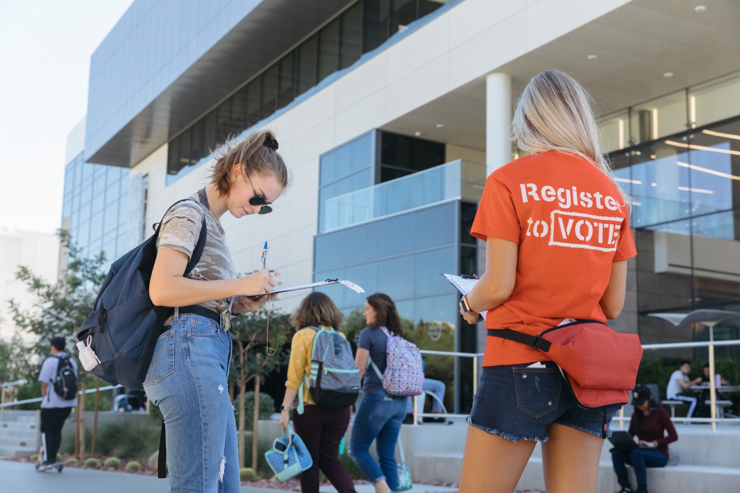 Two students at voter registration table