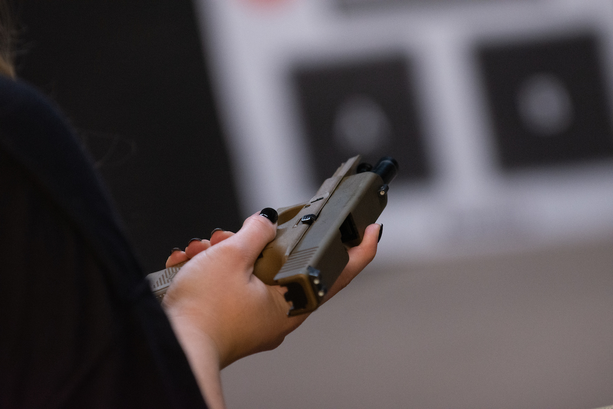 A handgun being held flat in a persons hands