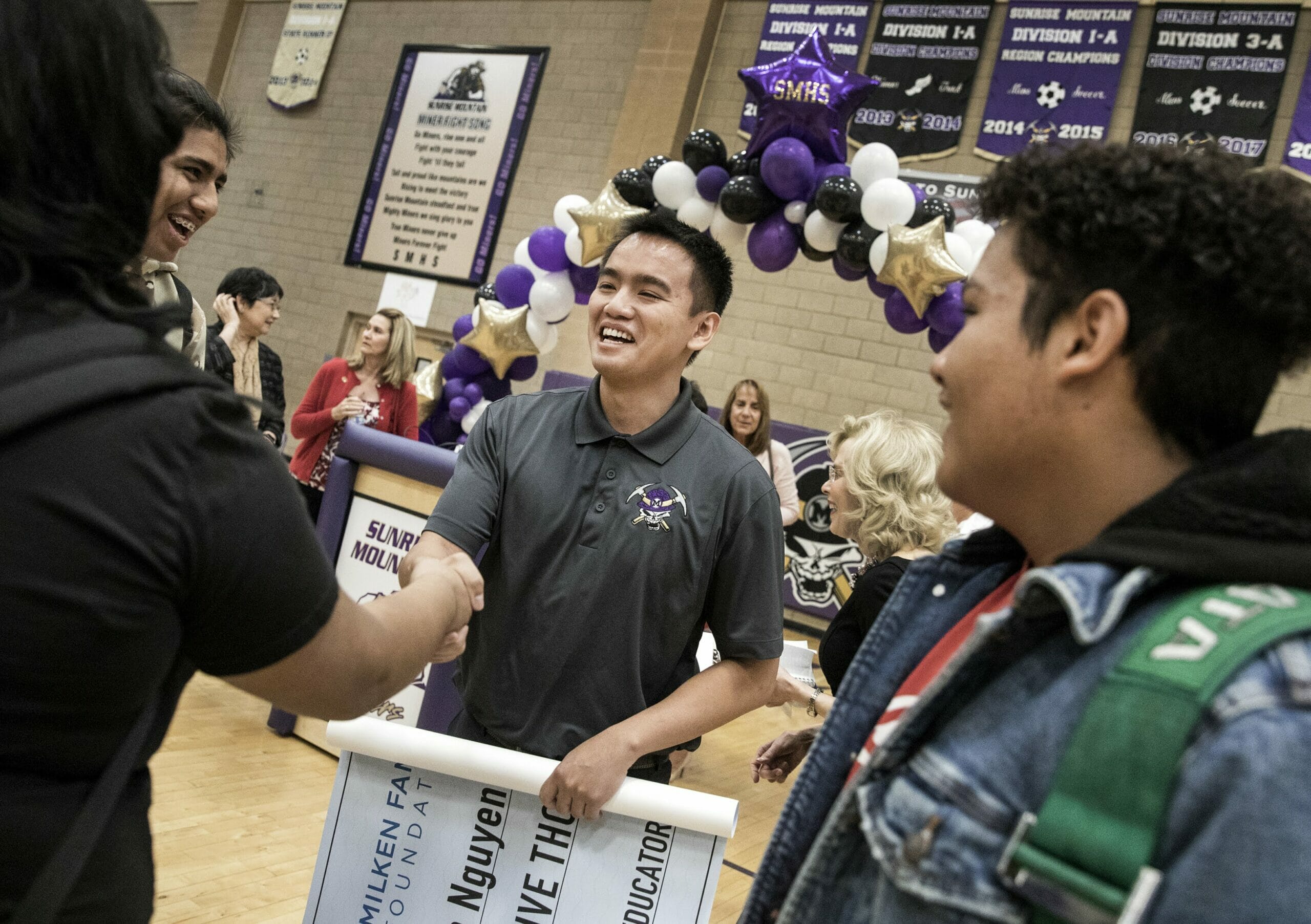 Ben Nguyen shaking hands with a student