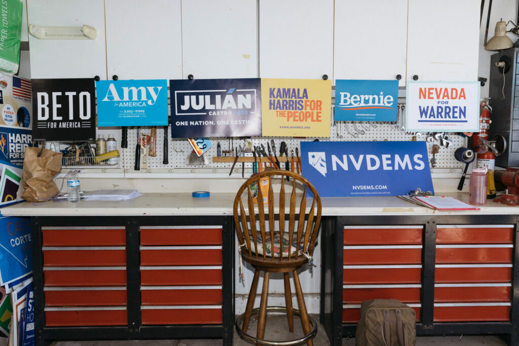 A desk and chair with Democratic party signs sitting on top.