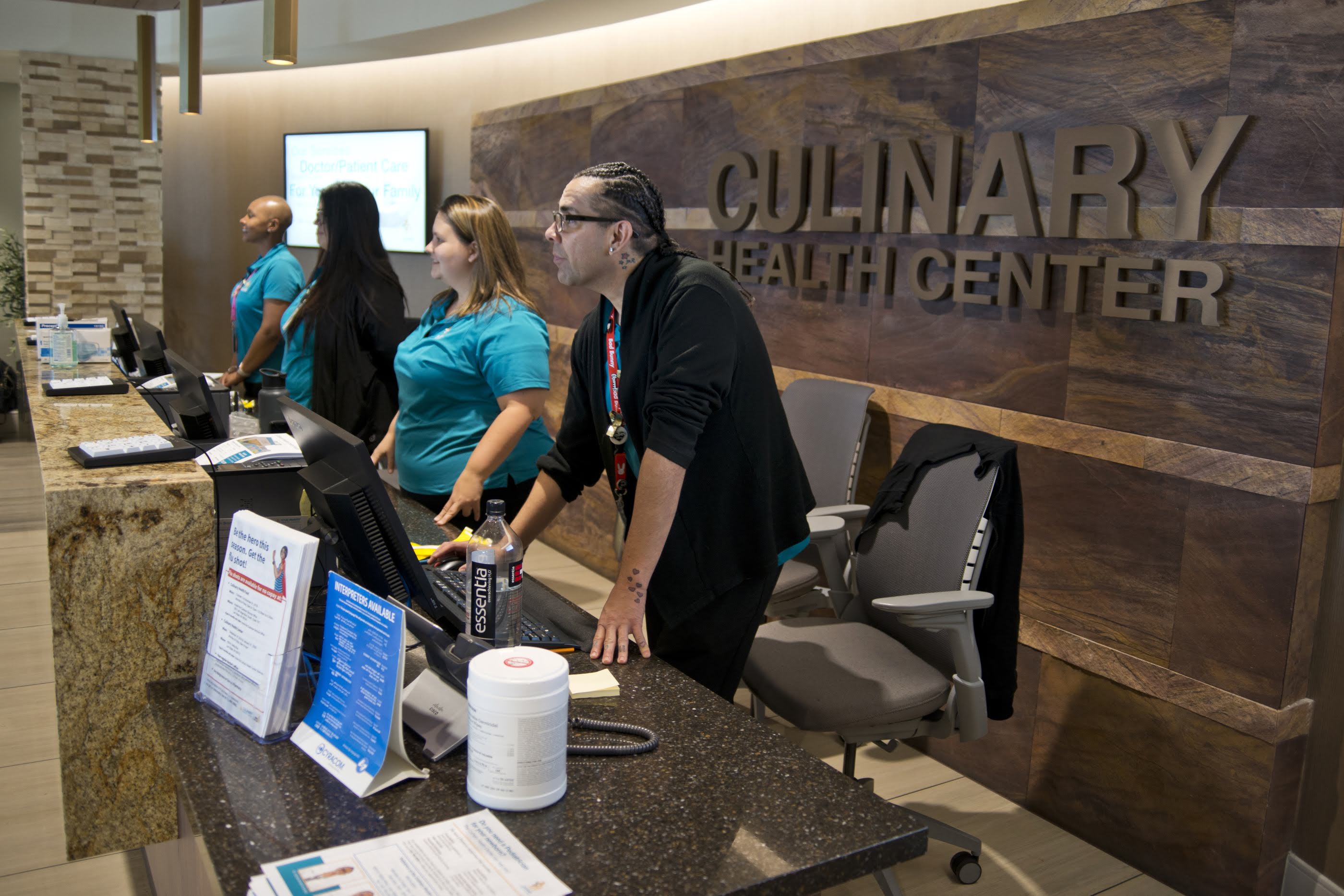 Employees at the front desk of a health clinic